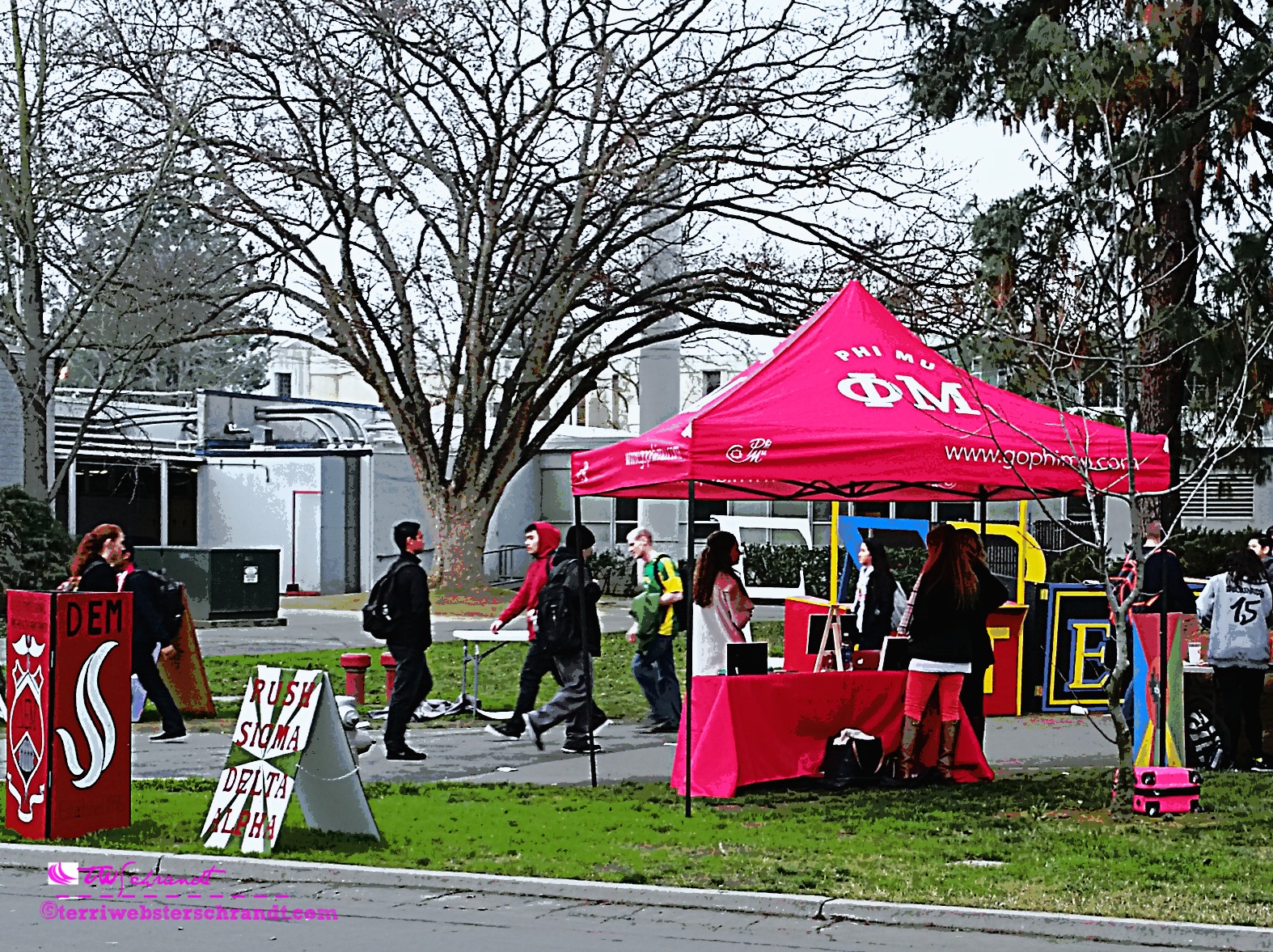 A bright pink tent beckons vibrant college students to explore leisure activities on campus.