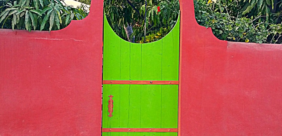 Vibrant gate guards a homey villa in Baja, Mexico.