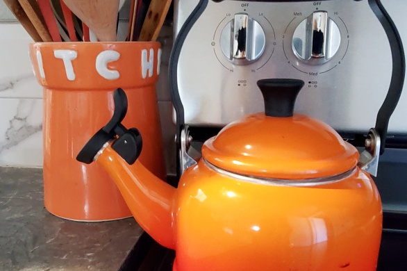 Smiling orange teapot